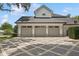 This beautiful home boasts a three-car garage with a gray roof and an elegant driveway at 1761 Legion Dr, Winter Park, FL 32789