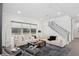 Bright living room featuring a large window, staircase, and contemporary furnishings for stylish comfort at 1761 Legion Dr, Winter Park, FL 32789