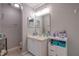 This bathroom features a vanity with storage and a large, well-lit mirror at 177 Bristol Forest Trl, Sanford, FL 32771