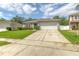 Well-maintained home with a two-car garage, green lawn, and trimmed hedges at 177 Bristol Forest Trl, Sanford, FL 32771