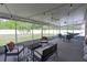This screened patio features a ceiling fan, comfortable seating and overhead string lights for an inviting area at 177 Bristol Forest Trl, Sanford, FL 32771