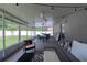 This screened patio features a ceiling fan, comfortable seating and overhead string lights for an inviting area at 177 Bristol Forest Trl, Sanford, FL 32771