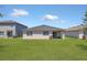Expansive backyard with lush green grass and covered patio is perfect for outdoor entertaining at 1866 Cassidy Knoll Dr, Kissimmee, FL 34744