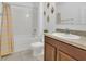 Well-lit bathroom features a shower and tub, vanity, mirror, and decorative accents at 1866 Cassidy Knoll Dr, Kissimmee, FL 34744
