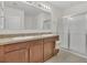 Bathroom featuring dual sinks, a walk-in shower, and plenty of counter space at 1866 Cassidy Knoll Dr, Kissimmee, FL 34744