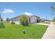 Well-maintained home exterior with lush green lawn and landscaping, offering great curb appeal in a suburban setting at 1866 Cassidy Knoll Dr, Kissimmee, FL 34744