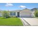 Charming single-story home featuring a well-manicured lawn, a two-car garage, and a welcoming front entrance at 1866 Cassidy Knoll Dr, Kissimmee, FL 34744