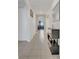 Inviting hallway featuring neutral tile flooring, an arched doorway, and a stylish console table with decorative items at 1866 Cassidy Knoll Dr, Kissimmee, FL 34744