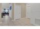 Bright hallway showcases neutral paint, modern tile flooring, and views into the open-concept living area at 1866 Cassidy Knoll Dr, Kissimmee, FL 34744
