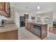 Bright kitchen with stainless steel appliances, tile flooring, and a breakfast bar at 1866 Cassidy Knoll Dr, Kissimmee, FL 34744