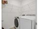 Laundry room with a modern washer and dryer and wire shelving for storage at 1866 Cassidy Knoll Dr, Kissimmee, FL 34744