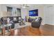 Comfortable living room boasts hardwood floors, a plush sectional sofa, and a large television for relaxing entertainment at 1866 Cassidy Knoll Dr, Kissimmee, FL 34744