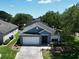 Aerial view of single-story home with manicured lawn, two car garage, and landscaped gardens at 1868 Rachels Ridge Loop # L, Ocoee, FL 34761