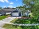 Aerial view of a single-story home with a green lawn and mature trees at 1868 Rachels Ridge Loop # L, Ocoee, FL 34761