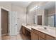 Bright, spacious bathroom with double vanity, large mirror, and tile floors at 1868 Rachels Ridge Loop # L, Ocoee, FL 34761