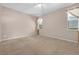 Bedroom featuring carpeted floors, neutral walls, and two large windows at 1868 Rachels Ridge Loop # L, Ocoee, FL 34761