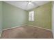 The bedroom has neutral carpet and green walls at 1868 Rachels Ridge Loop # L, Ocoee, FL 34761