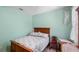 Green bedroom with a bed, dresser, and nightstand set illuminated by natural light at 1868 Rachels Ridge Loop # L, Ocoee, FL 34761