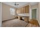 The room features custom built-in desk and cabinets, as well as neutral carpet at 1868 Rachels Ridge Loop # L, Ocoee, FL 34761