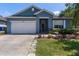 Charming single-story home featuring an attached garage and lush landscaping at 1868 Rachels Ridge Loop # L, Ocoee, FL 34761