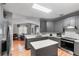Open kitchen featuring an island, stainless steel appliances, gray cabinets and a subway tile backsplash at 1868 Rachels Ridge Loop # L, Ocoee, FL 34761