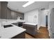 Kitchen featuring gray cabinets, quartz counters, subway tile backsplash, and island at 1868 Rachels Ridge Loop # L, Ocoee, FL 34761