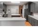 Modern gray kitchen with quartz countertops, white backsplash, and stainless steel appliances at 1868 Rachels Ridge Loop # L, Ocoee, FL 34761