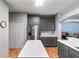 Spacious kitchen with gray cabinets, stainless steel refrigerator, and a center island at 1868 Rachels Ridge Loop # L, Ocoee, FL 34761