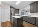 Kitchen with gray cabinets, stainless appliances, and island with white countertop at 1868 Rachels Ridge Loop # L, Ocoee, FL 34761