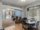 Open-concept living room and dining space with wood floors and arched doorway at 1868 Rachels Ridge Loop # L, Ocoee, FL 34761