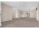 Open-concept living room featuring neutral walls, carpeted floors, and ceiling fan at 1868 Rachels Ridge Loop # L, Ocoee, FL 34761