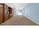 Blue living room featuring built-in wood cabinet, ceiling fan, and sliding glass doors at 1868 Rachels Ridge Loop # L, Ocoee, FL 34761