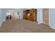 Living area with light blue walls, carpeted floor, and wooden entertainment center at 1868 Rachels Ridge Loop # L, Ocoee, FL 34761