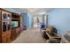 Cozy living room with blue walls, a wooden entertainment center, and comfortable seating at 1868 Rachels Ridge Loop # L, Ocoee, FL 34761