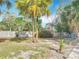 A spacious backyard with palm trees and a well-maintained wooden fence is perfect for outdoor activities at 1901 Rose Blvd, Orlando, FL 32839