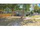 Secluded backyard featuring a privacy fence, mature trees, and a well-maintained lawn at 1901 Rose Blvd, Orlando, FL 32839