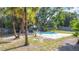 Private backyard with an in-ground pool and mature tropical landscaping at 1901 Rose Blvd, Orlando, FL 32839