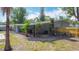 The backyard has mature landscaping, a covered patio with space to enjoy the outdoors at 1901 Rose Blvd, Orlando, FL 32839