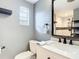 A cozy bathroom with vanity and sink, toilet and glass-door shower at 1901 Rose Blvd, Orlando, FL 32839
