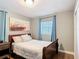 Comfortable bedroom with hardwood floors, soft lighting, and light-blocking blue curtains at 1901 Rose Blvd, Orlando, FL 32839
