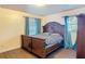 Comfortable bedroom featuring a large wood bed, ample natural light, and wood-look floors at 1901 Rose Blvd, Orlando, FL 32839
