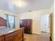 Inviting bedroom featuring a large wooden dresser, matching bed frame, and ample natural light at 1901 Rose Blvd, Orlando, FL 32839