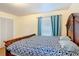 Spacious bedroom boasting a large wooden bed frame, natural light, and wood-look floors at 1901 Rose Blvd, Orlando, FL 32839