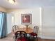 Cozy dining area with a round wooden table and chairs, adjacent to the kitchen at 1901 Rose Blvd, Orlando, FL 32839