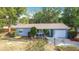 Charming single-story home with a well-manicured lawn and a brick driveway at 1901 Rose Blvd, Orlando, FL 32839