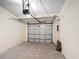 View of the garage featuring a gray door, detailed floor, and motorized door opening system at 1901 Rose Blvd, Orlando, FL 32839