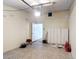 Garage interior showing tile floor, white cabinets and door to house at 1901 Rose Blvd, Orlando, FL 32839