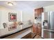 Bright kitchen with stainless steel refrigerator, granite countertop breakfast bar, and a dining table at 1901 Rose Blvd, Orlando, FL 32839