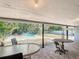 View from covered patio toward backyard pool and tropical landscaping at 1901 Rose Blvd, Orlando, FL 32839
