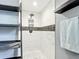 Newly renovated shower featuring white marble-look tiles with dark slate accent stripe at 1901 Rose Blvd, Orlando, FL 32839